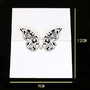 Detail of white 9x12cm laser cut butterfly place card with intricate floral hollow design