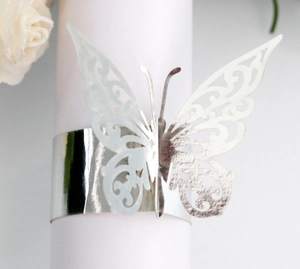 Detailed view of silver laser-cut butterfly napkin ring with intricate floral patterns