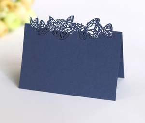 Detailed laser-cut butterfly design on dark blue pearlescent paper table card