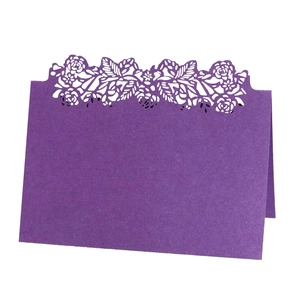 Elegant purple laser-cut wedding place card with hollow rose design on white background