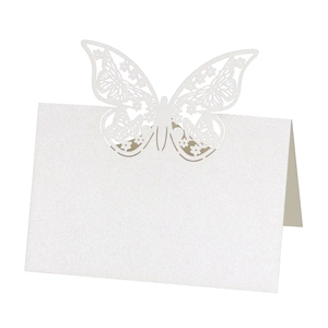 Detailed laser-cut hollow butterfly table card in white glitter paper for wedding seating