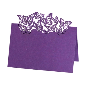 Macro view of purple laser-cut butterfly place card with intricate镂空 craftsmanship