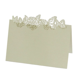 Detail of laser-cut butterfly seat card with champagne pearl finish for weddings