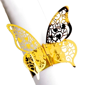 Detail of laser-cut gold butterfly napkin ring with intricate hollow floral patterns