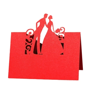 Detailed laser-cut bride and groom silhouette on red wedding table place card