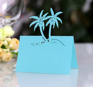 Detailed laser-cut blue place card featuring coconut trees for beach wedding tables