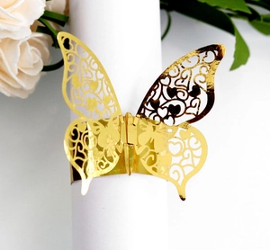 Detailed laser-cut gold butterfly napkin ring with hollow heart patterns for weddings