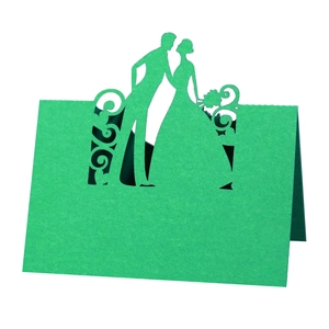 Detailed laser-cut grass green wedding place card featuring a romantic couple silhouette