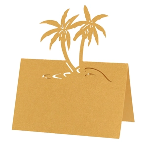 Detail of laser-cut palm tree design on a golden pearlescent paper wedding place card