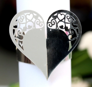 Detailed macro view of laser-cut heart napkin ring with intricate scrollwork patterns