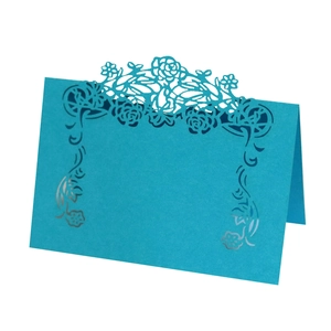 Detail view of teal laser-cut floral place card made of high-quality art paper