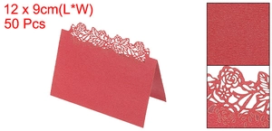 Detail of red laser-cut wedding place cards with elegant floral patterns and pearl texture