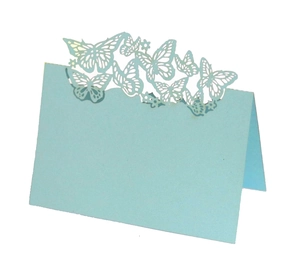 Detail of light blue laser-cut butterfly place card with elegant hollow design for weddings