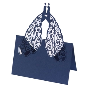 Detailed laser-cut navy blue peacock wedding place card with intricate镂空patterns