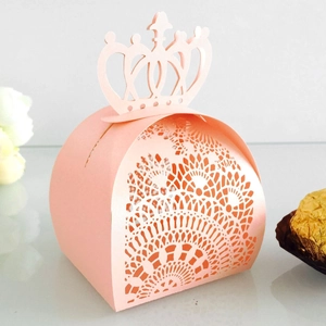 Detail of pink crown candy box with laser-cut hollow pattern and gold chocolate