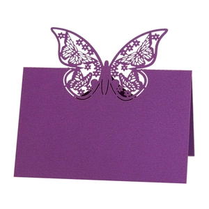 Detail of laser-cut butterfly place card in deep purple for wedding table settings