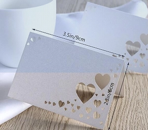 Detailed view of white hollow heart place card with 3.5x2.3 inch size measurements