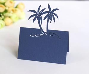 Detail of navy blue 3D laser-cut coconut tree place card for beach wedding table decor