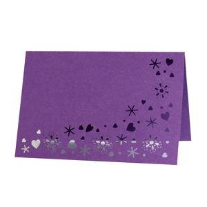 Deep purple laser-cut heart place card with intricate butterfly patterns for wedding events