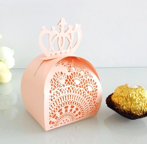 Detailed laser cut lace patterns on a pink crown shaped hollow wedding candy gift box