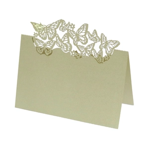 Close-up of laser-cut butterfly hollow design on white folded wedding place card