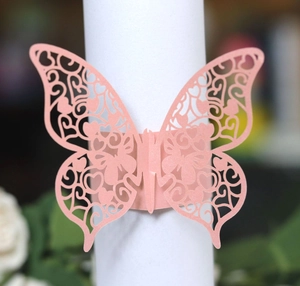 Close-up of pink laser-cut butterfly napkin ring with intricate heart hollow patterns