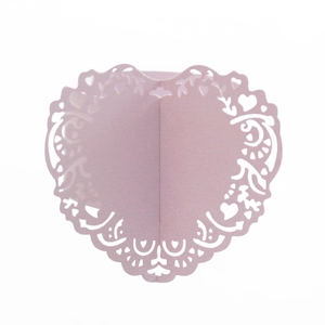 Detailed laser-cut heart pattern on light purple paper napkin ring for wedding decor
