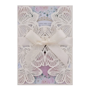 Elegant laser-cut white rose wedding invitation card with satin bow and floral inner sheet
