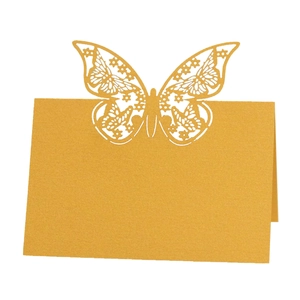 Golden laser-cut butterfly place card for weddings with a pearlescent paper texture finish