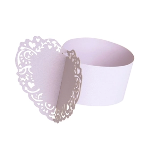Detailed view of light purple laser-cut filigree heart napkin ring for wedding decor
