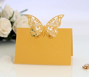 Detailed laser-cut butterfly place card with golden pearlescent texture for wedding decor