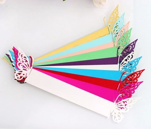Macro detail of laser-cut butterfly napkin rings in various vibrant colors for parties