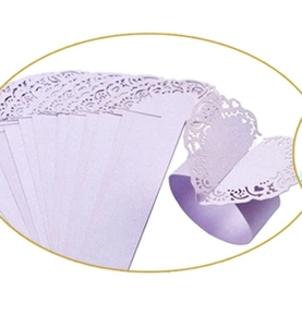 Close-up of laser-cut lavender pearl paper napkin rings with hollow heart patterns