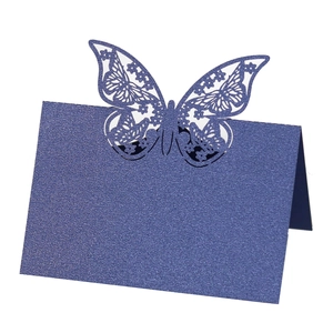 Detailed laser-cut butterfly place card in navy blue pearlescent paper for wedding decor