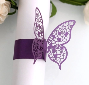 Detailed laser-cut dark purple butterfly napkin ring with intricate heart pattern