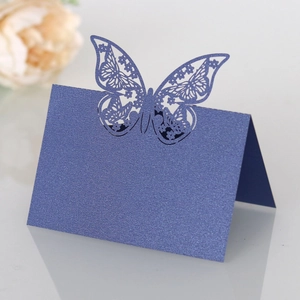 Macro shot of dark blue laser-cut butterfly place card with a pearlescent shimmer finish