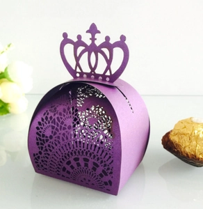 Macro shot of purple crown gift box with intricate laser-cut patterns and pearlescent paper