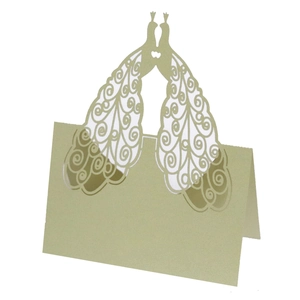 Close-up of laser-cut peacock place card with intricate patterns for wedding table