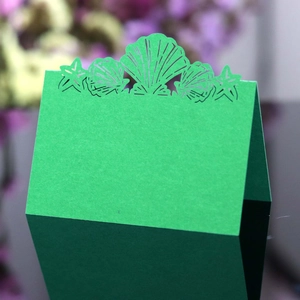 Laser-cut green shell and starfish place card for wedding reception table seating