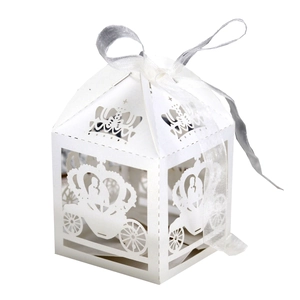 White laser-cut hollow candy box with pumpkin carriage design and white ribbon bow