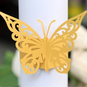 Laser-cut butterfly napkin ring in golden shimmer pearl paper for wedding decor