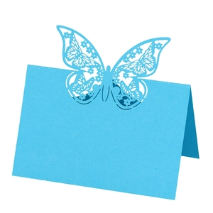 Detailed laser-cut butterfly place card in light blue for wedding table decoration