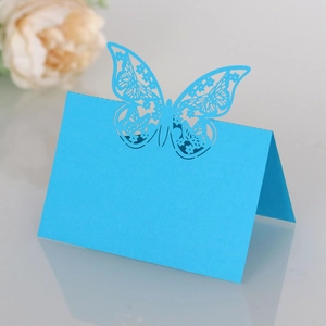 Detail of laser-cut hollow butterfly table card in bright royal blue paper for weddings