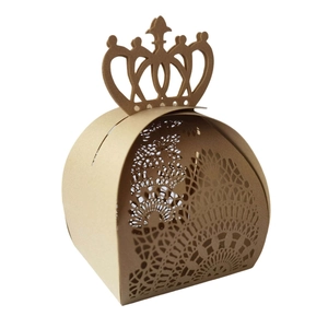 Detail of laser-cut crown gift box with intricate mandala pattern on brown kraft paper