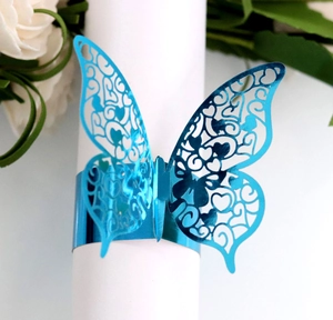 Macro view of blue laser-cut butterfly napkin ring with intricate wing patterns
