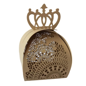 Macro shot of laser-cut crown candy box showing detailed mandala patterns on kraft paper