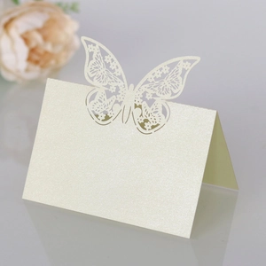 Detailed view of cream laser-cut butterfly place card with elegant pearl paper texture