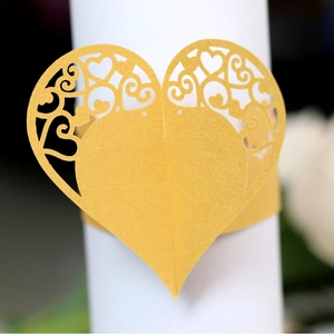 Matte gold laser-cut heart napkin ring with intricate hollow floral vine patterns