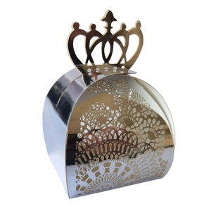 Close-up of laser-cut hollow crown candy box with intricate floral patterns and gold finish