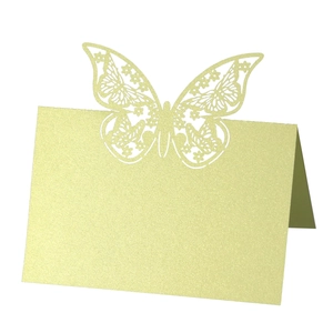 Detail of laser-cut butterfly place card with gold glitter finish and hollow pattern